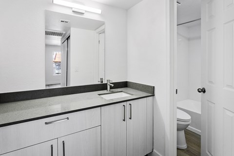 A white bathroom with a sink and toilet.