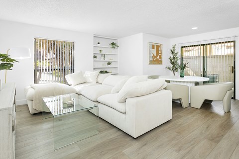 a living room with a white couch and a table