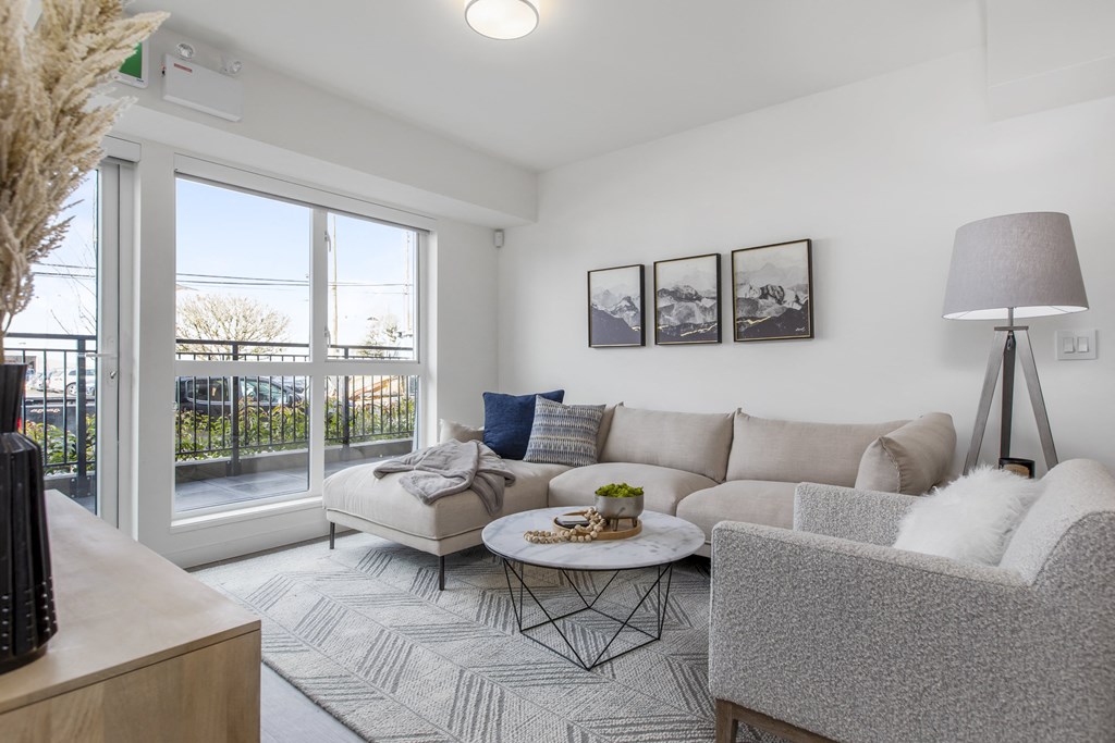 a living room with a couch and a chair and a sliding glass door