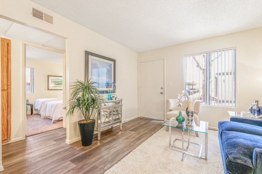 a living room with a couch and a table     and a bedroom