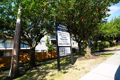 A sign for Fraser Property is displayed in front of a building.