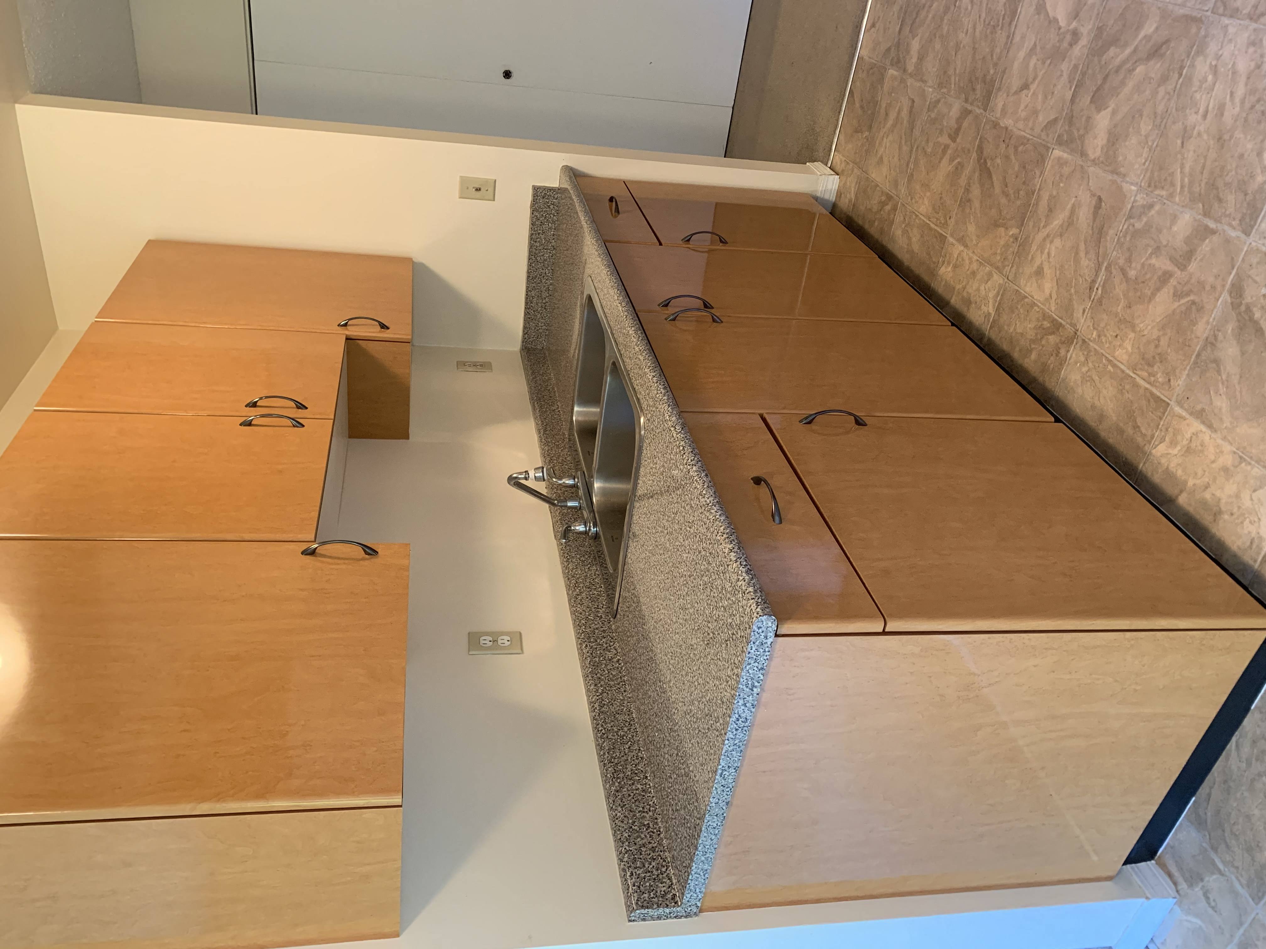 A kitchen with wooden cabinets and a countertop.