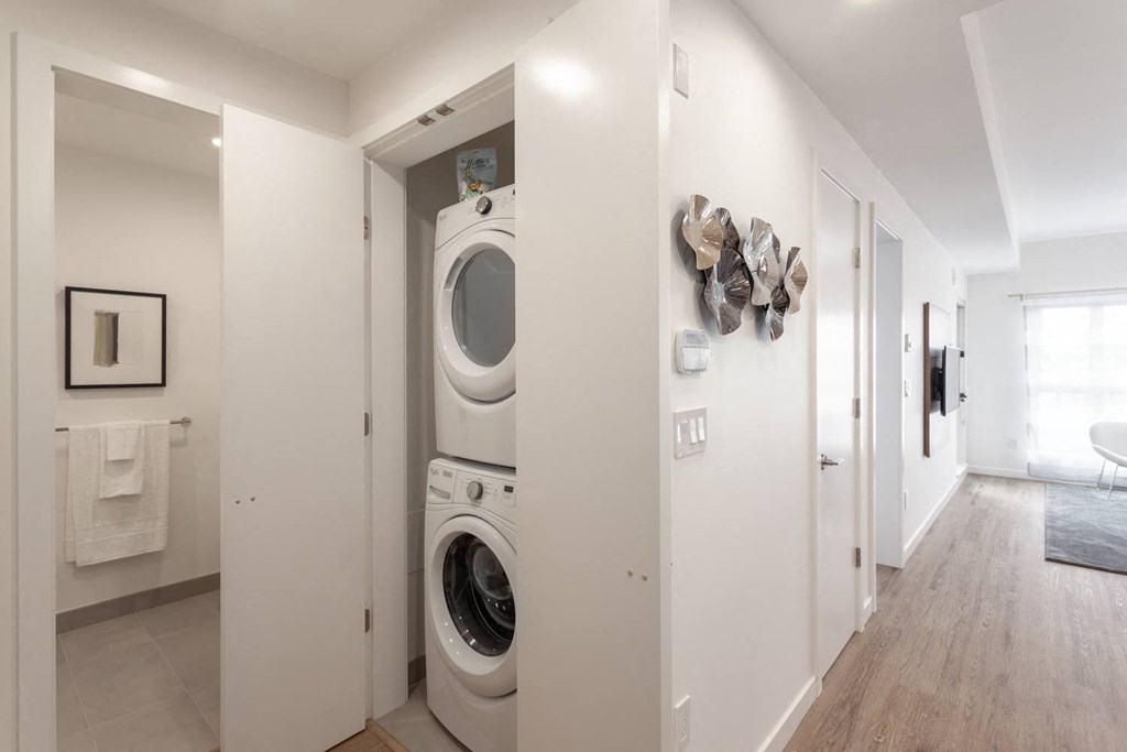 a washer and dryer in a white laundry room