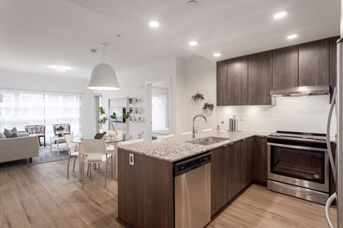 A modern kitchen with wooden cabinets and stainless steel appliances.