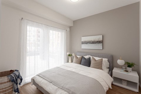 a bedroom with a large bed and a window