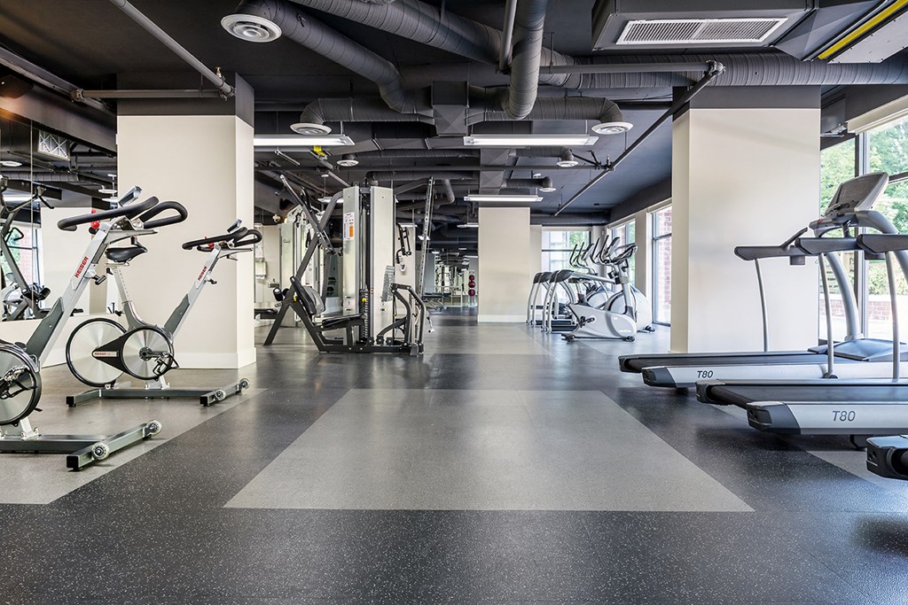 A gym with treadmills and exercise bikes.