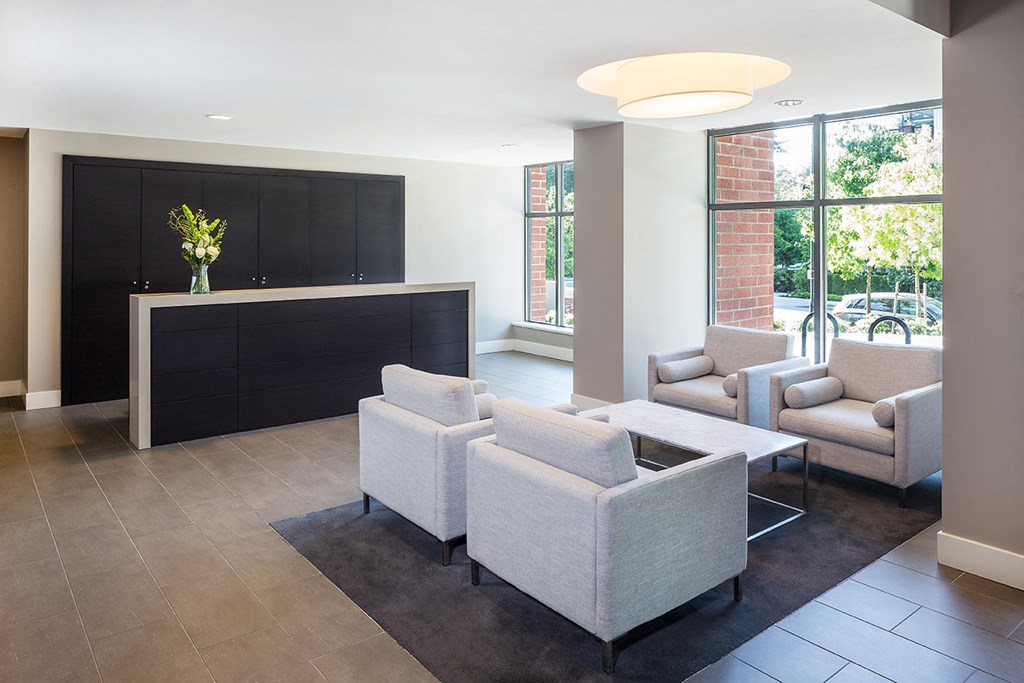 A black and white reception area with a flower vase on the counter.