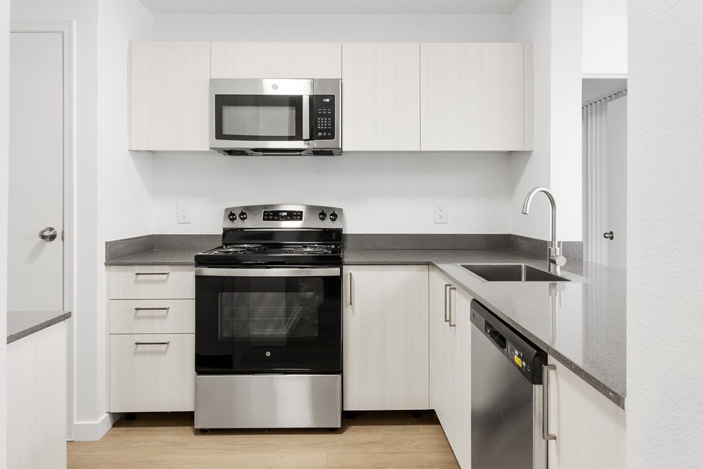 A modern kitchen with a stainless steel oven and microwave.