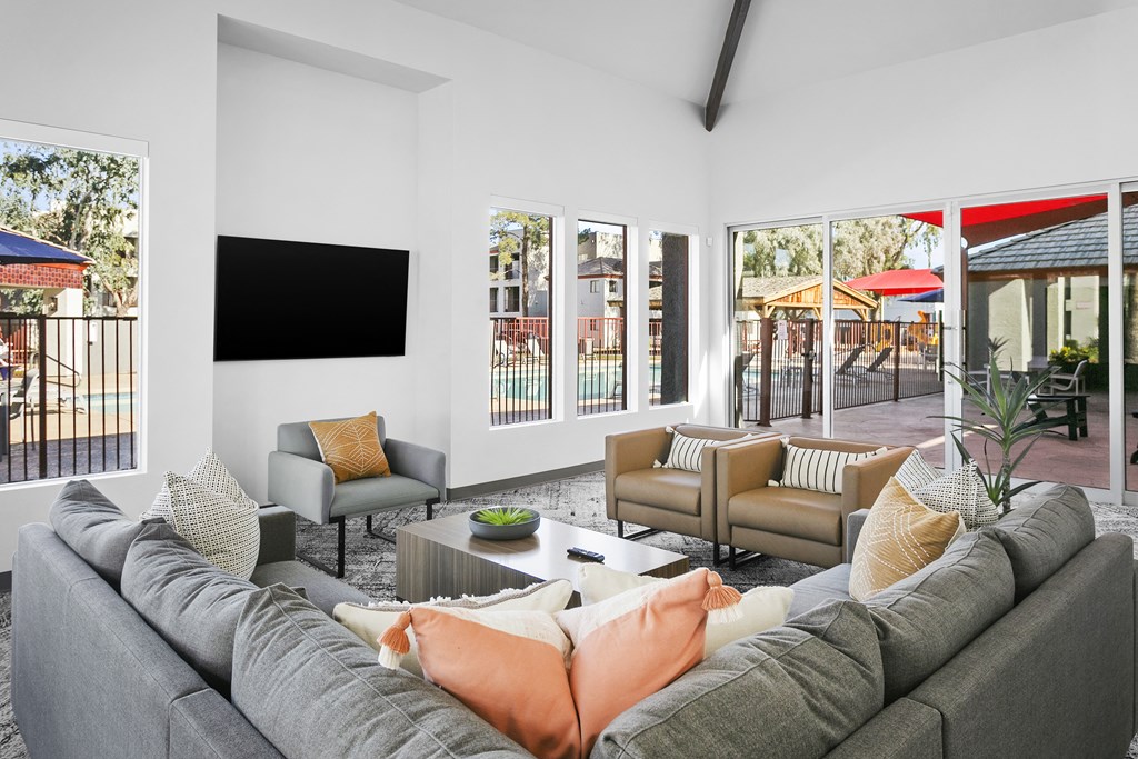 a living room with white walls and a large gray couch