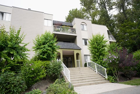 A house with a staircase leading to the front door.