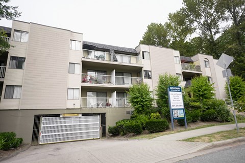 Apartment complex with a sign in front of it.