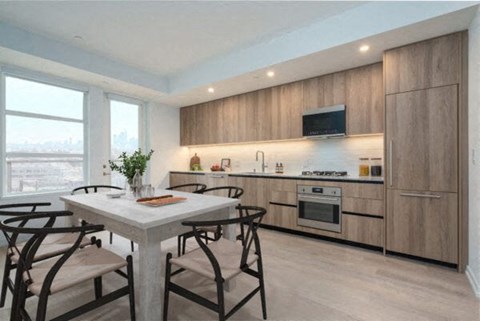 A modern kitchen with a dining table and chairs.