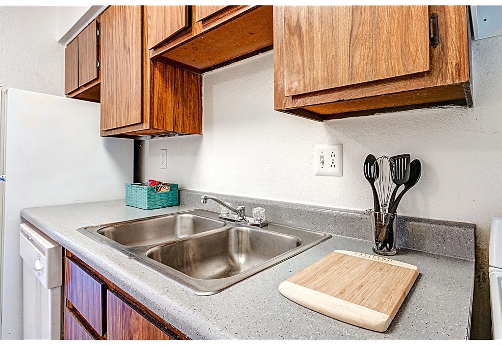a kitchen with a sink and wooden cabinets