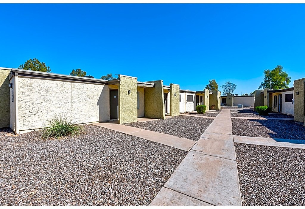 a row of buildings with a blue sky in the background