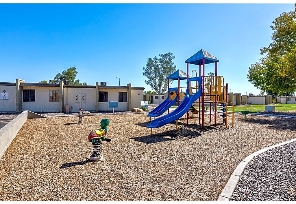 a small child playing in a playground at a park