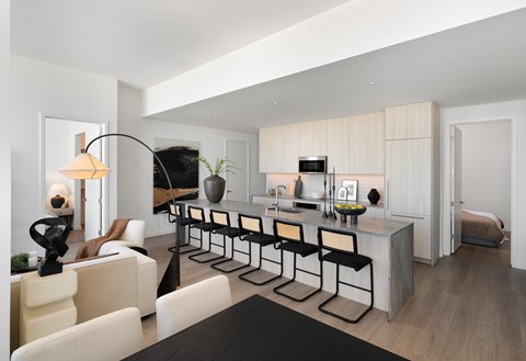 A modern living room with a black coffee table and white furniture.