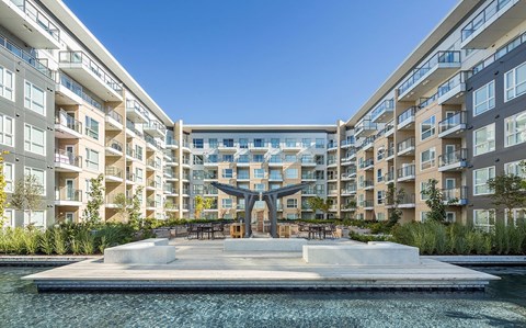 A modern building with a pool in front.