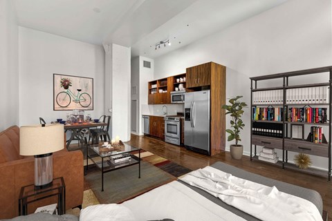 A modern living room with a white sofa and a bookshelf filled with books.