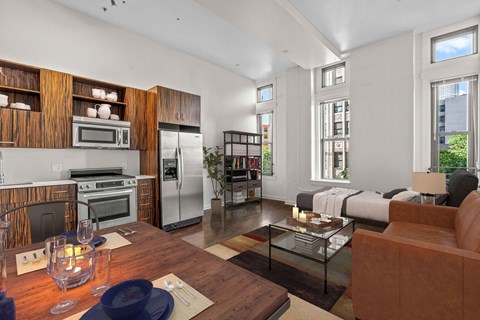 A modern kitchen with a dining table set for two.