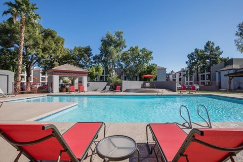 Resort style pool with lounge chairs and cabana at Villa de Cortez Apartments, Phoenix, AZ