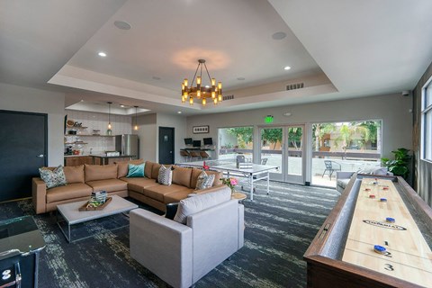 A room with a shiny black floor and a pool table.