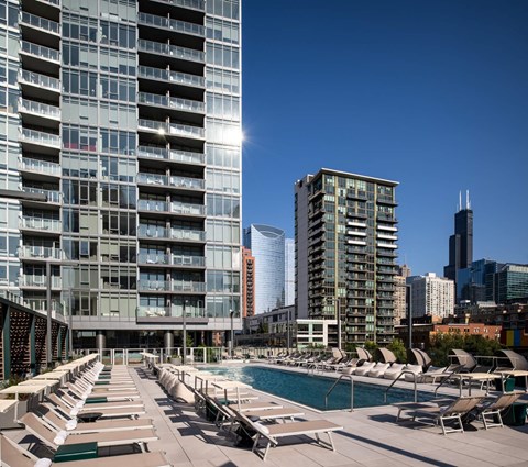Rooftop pool deck with lounge chairs and skyline views at Onni Fulton Market Apartments, Illinois, 60661