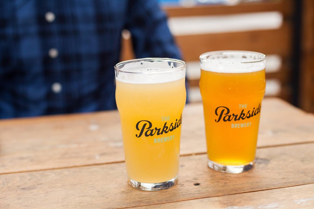 Two glasses of beer with the label