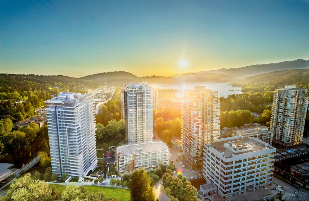 A cityscape with buildings and greenery under a clear sky.