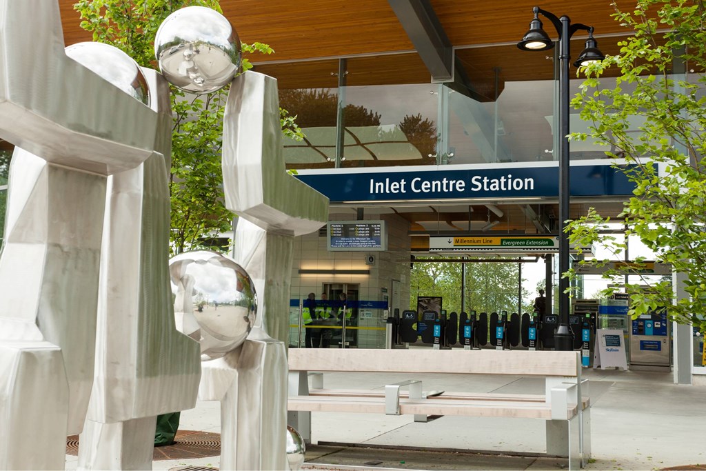 A train station with a sign that says Inlet Centre Station.