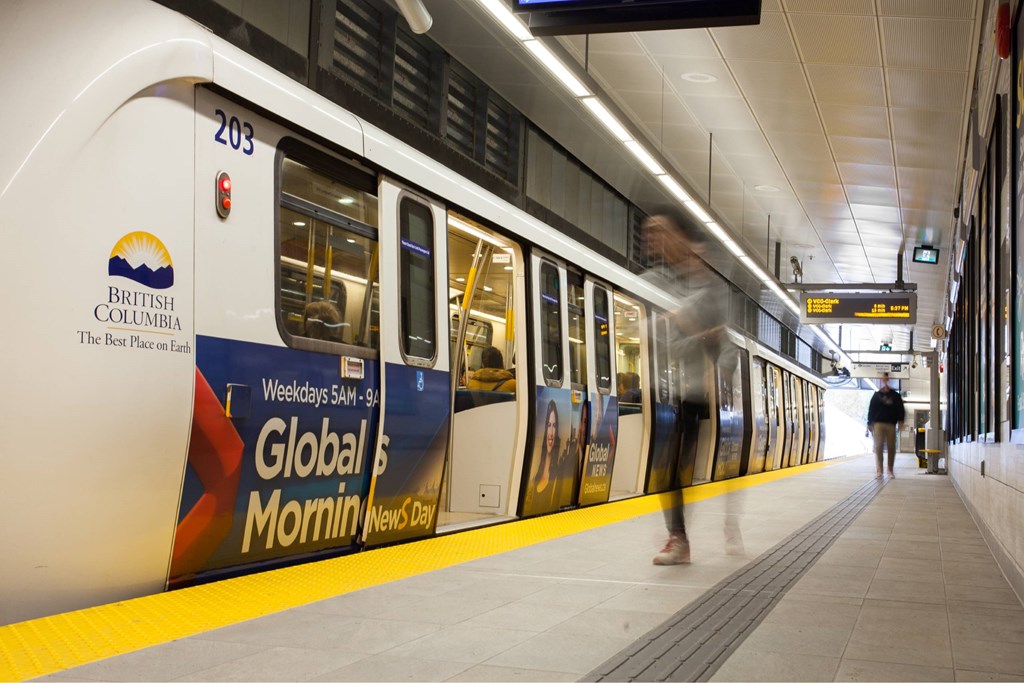A train with the number 203 on it is pulling into a station.