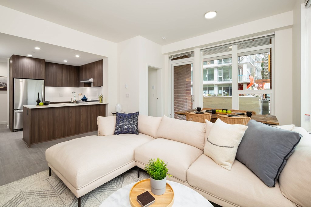 A modern living room with a white sofa and a wooden coffee table.