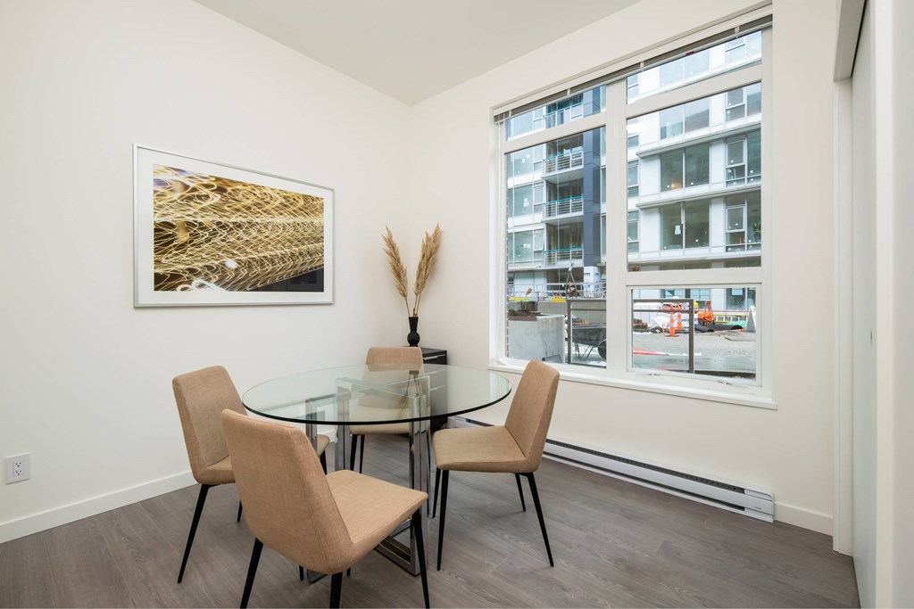 A dining room with a glass table and chairs.