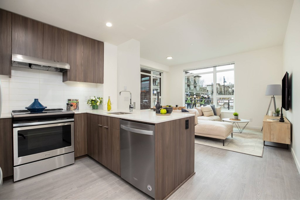 A modern kitchen with a stainless steel dishwasher and oven.