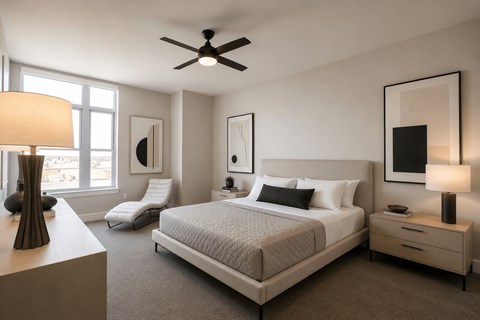 Modern bedroom with neutral tones and ceiling fan at Uptown by Onni Apartments, Dallas, TX