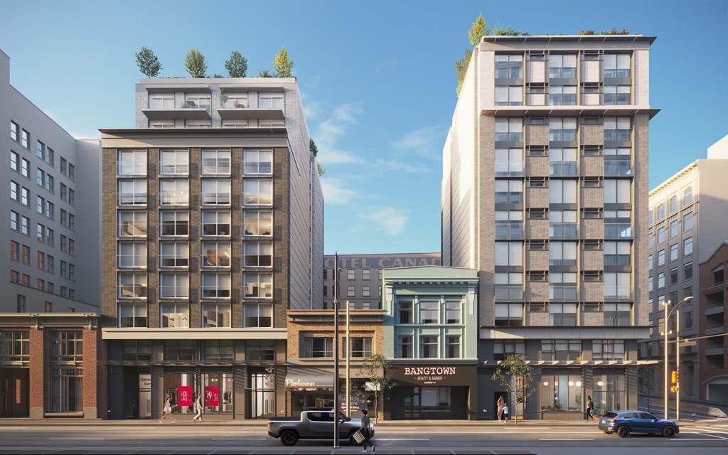 A street view of a city with buildings, cars, and a pedestrian.