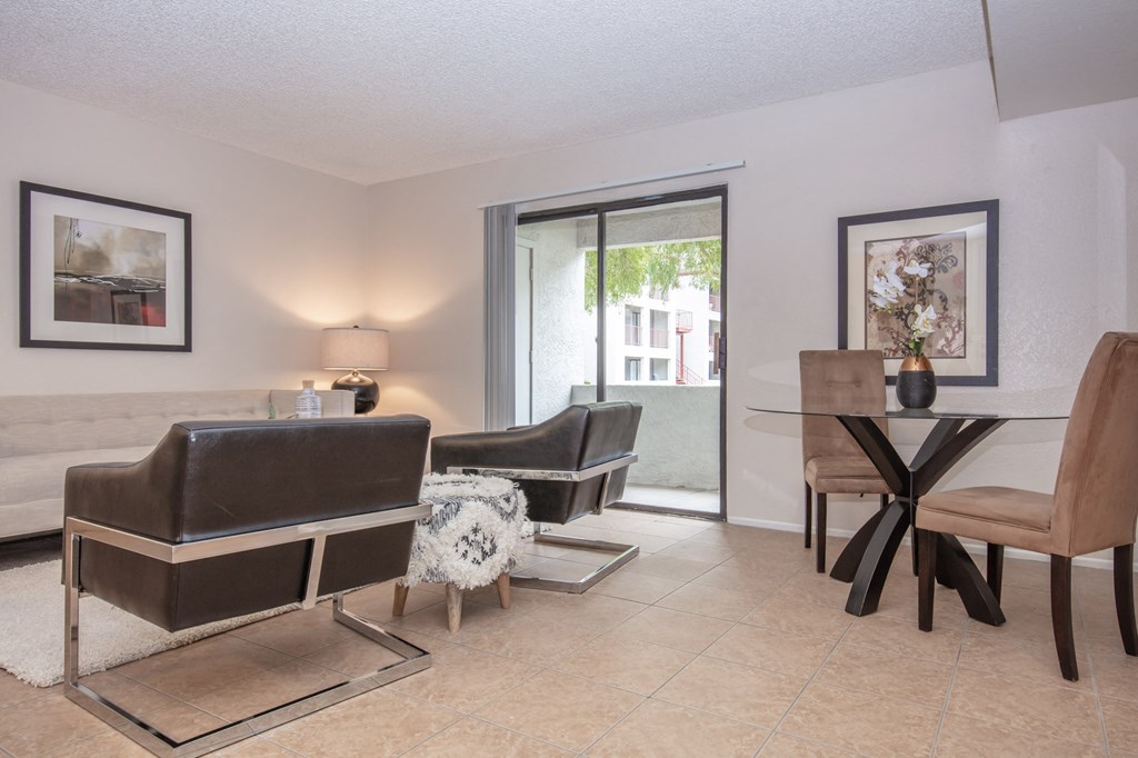 a living room with a couch and chairs and a table