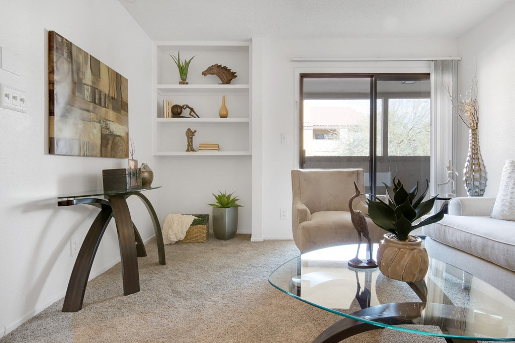 a living room with a couch and a glass table