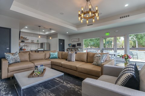 A living room with a large sectional sofa and a coffee table.