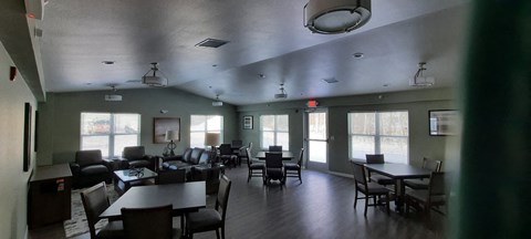 a large dining room with tables and chairs and windows
