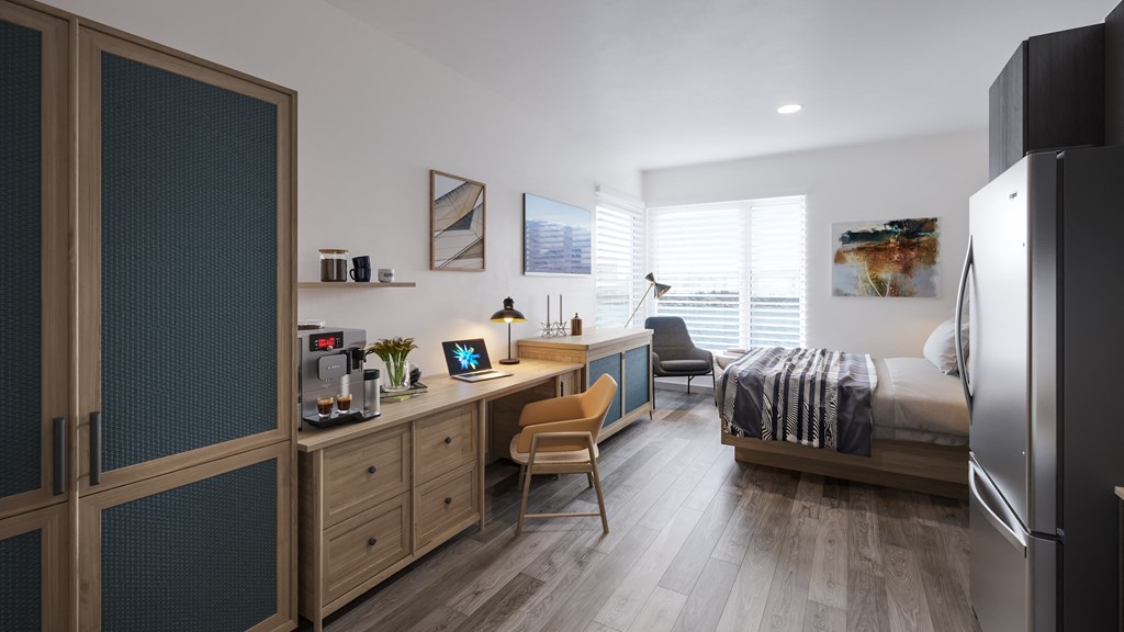 a bedroom with a bed and a desk in a room