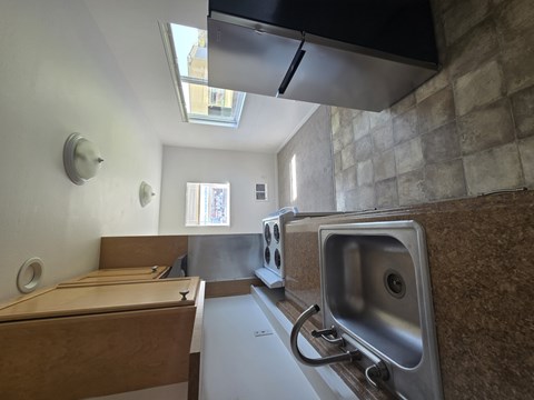 A kitchen with a sink and a window.