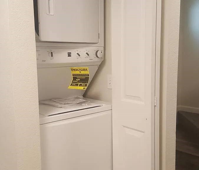 A yellow energy consumption label is on the back of a white dishwasher.