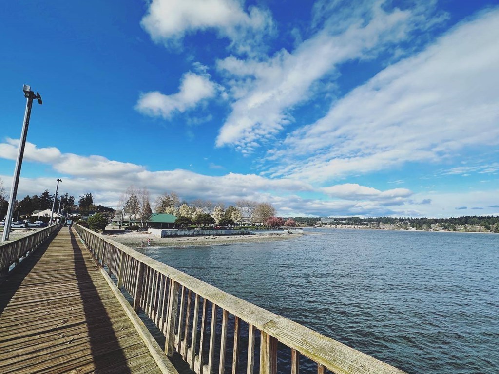 a wooden pier with a blue sky in the background at Rivulet, Washington, 98383