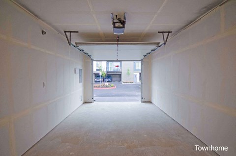 A long, empty garage with a view of the street outside at Spyglass Hill Apartments, Washington
