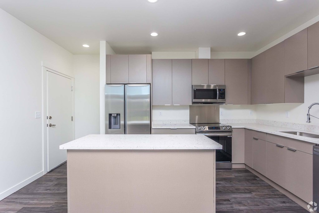A kitchen with a white countertop and brown cabinets. at Plisko Place, Port Orchard, WA, 98366