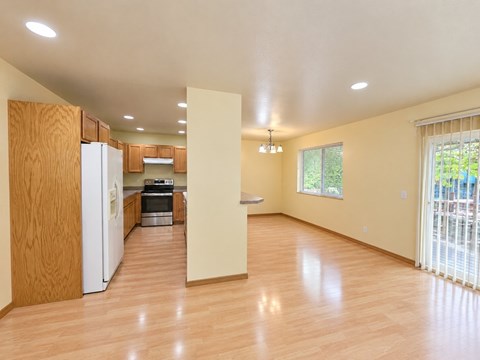 A kitchen with wooden cabinets and a white refrigerator.