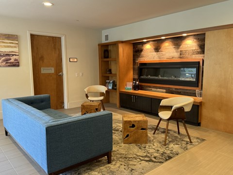 a living room with a couch and chairs and a television at Spyglass Hill Apartments, Bremerton