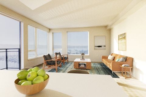 a living room with a couch and a table with a bowl of fruit on top of it