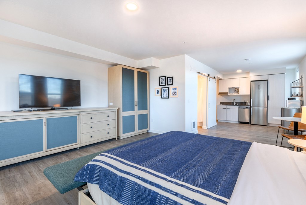 a bedroom with a bed and a tv in a room at Marina Square, Washington, 98337