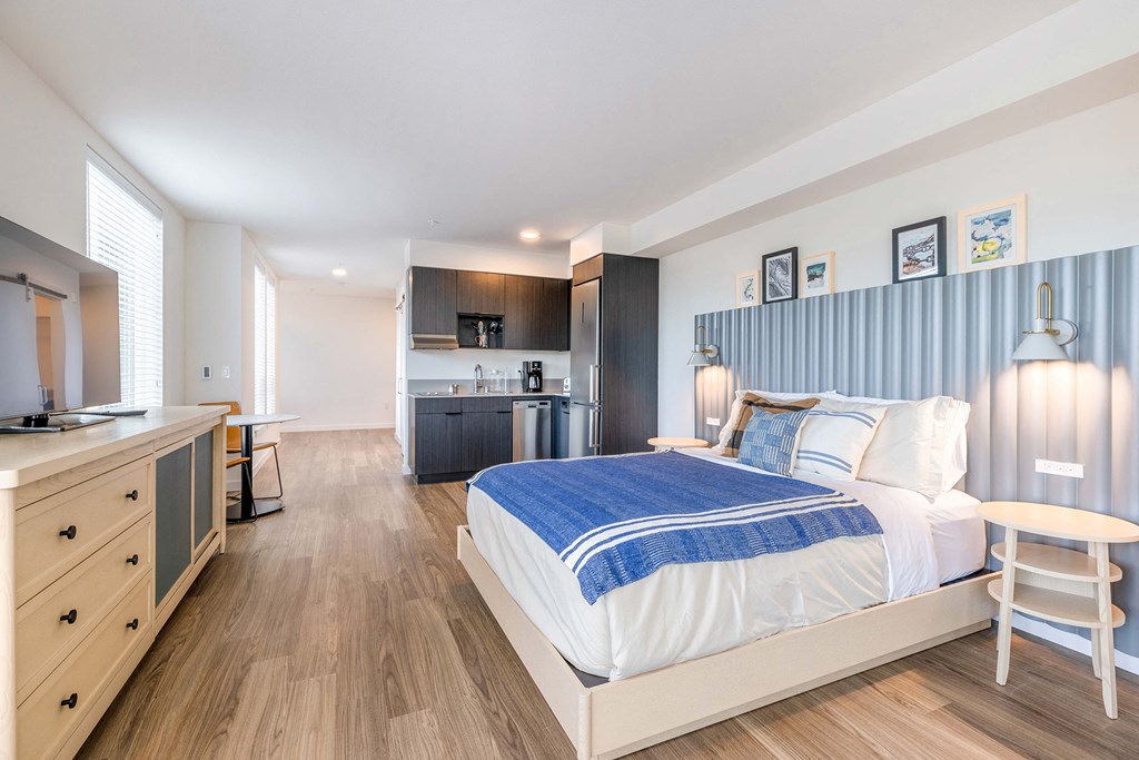 a bedroom with a bed and a desk in a room at Marina Square, Bremerton, WA